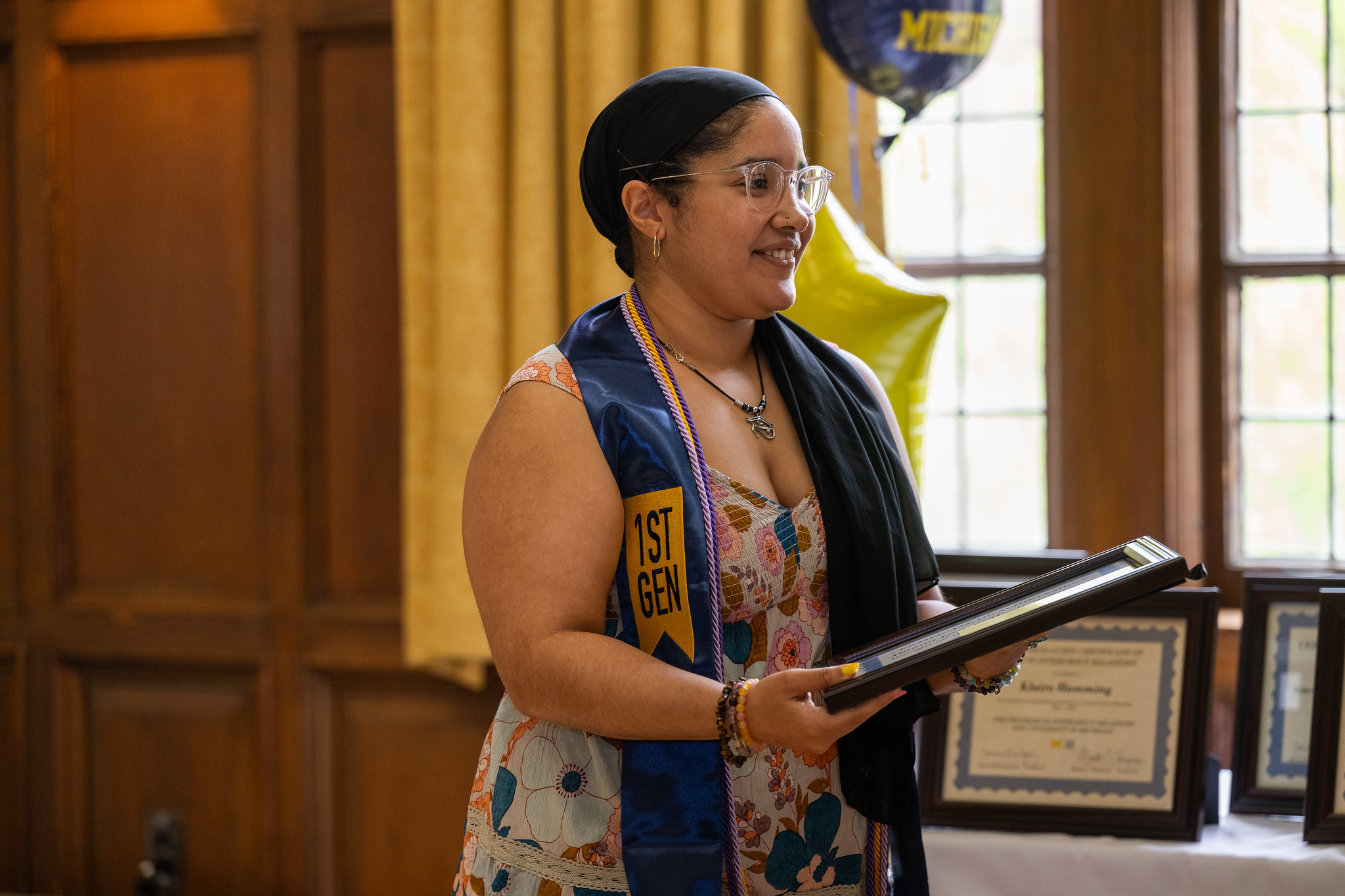 Photo of an IGR graduate holding their certificate