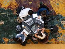 Photo taken from above of students studying at a round table.