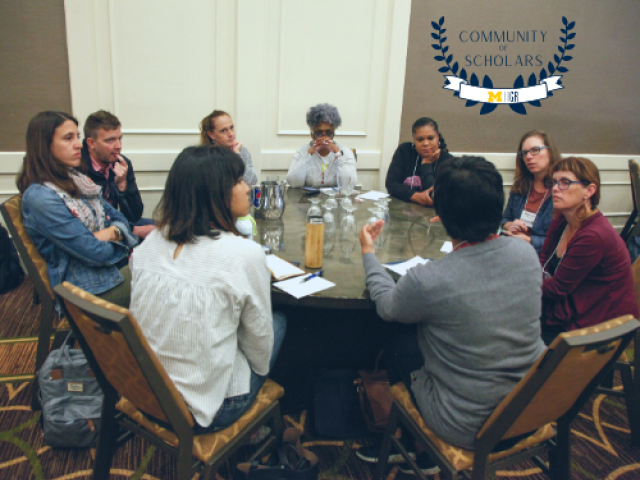 Photo of a group of the community of scholars sitting in a circle