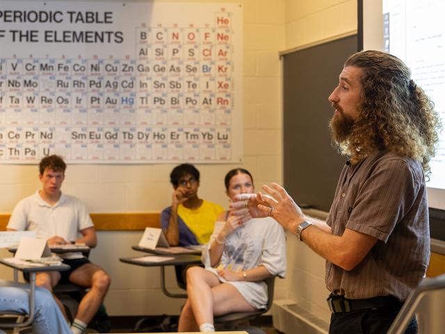 Jacob Foster speaks to their class